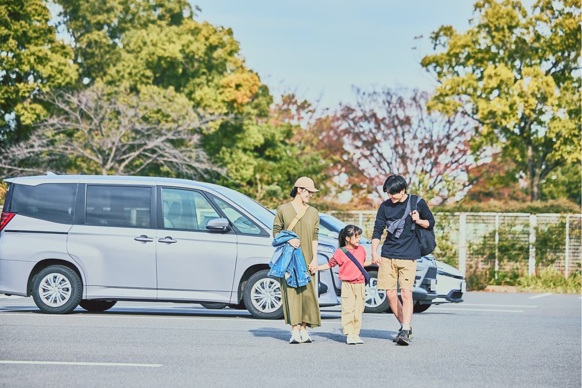 akippaを利用して予約した駐車場に停めた車の前で、手をつないで歩く家族の画面